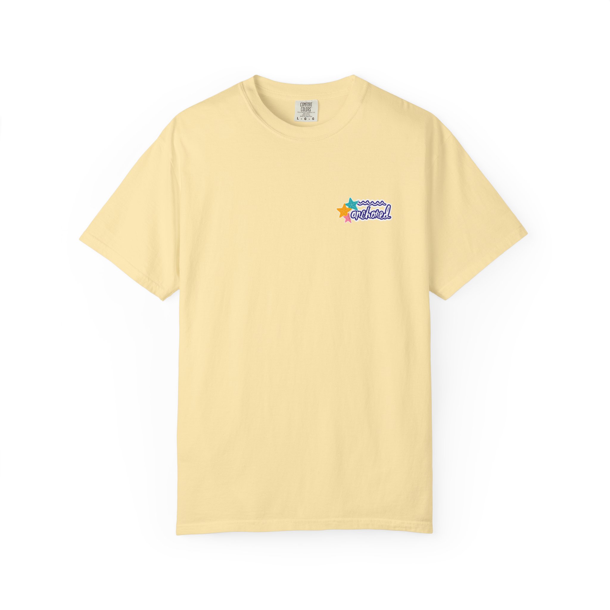 12972215710973562293_2048jpeg - Anchored Beige-yellow short-sleeve T-shirt laid flat with a small colorful star and wave graphic on the left chest and a visible interior tag at the neck.