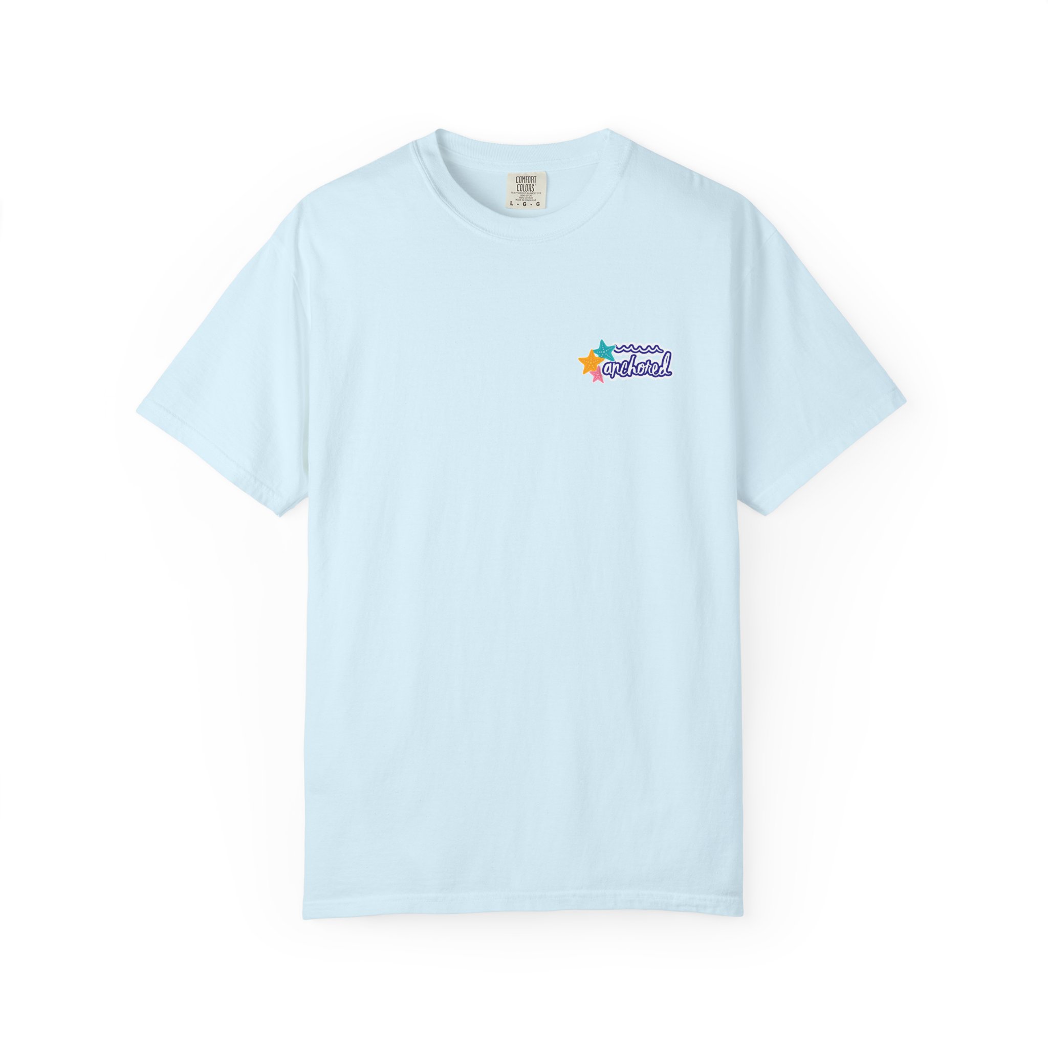 17967468612501125848_2048jpeg - Anchored Light-blue T-shirt with a small colorful beach-themed logo on the left chest that says 'anchored' surrounded by stars and waves.
