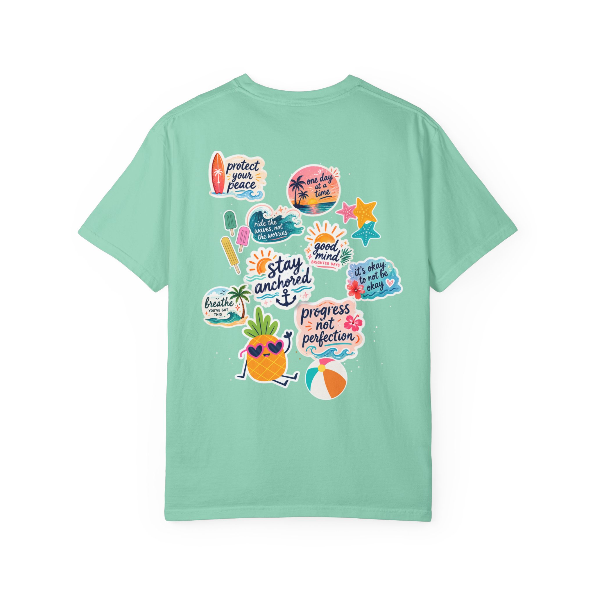 8217812074488704771_2048jpeg - Anchored Mint-green t-shirt showing a cluster of tropical stickers on the back, including surf imagery and sun icons, decorative and colorful.